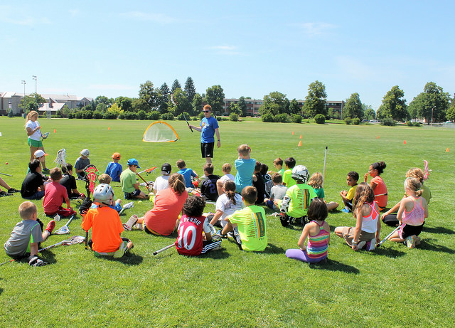Kids sitting in circle at Youth Sport Camp
